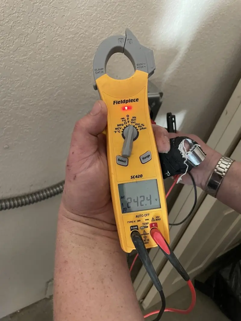 Voltage testing with clamp meter during Recessed Lighting Installation in Braselton